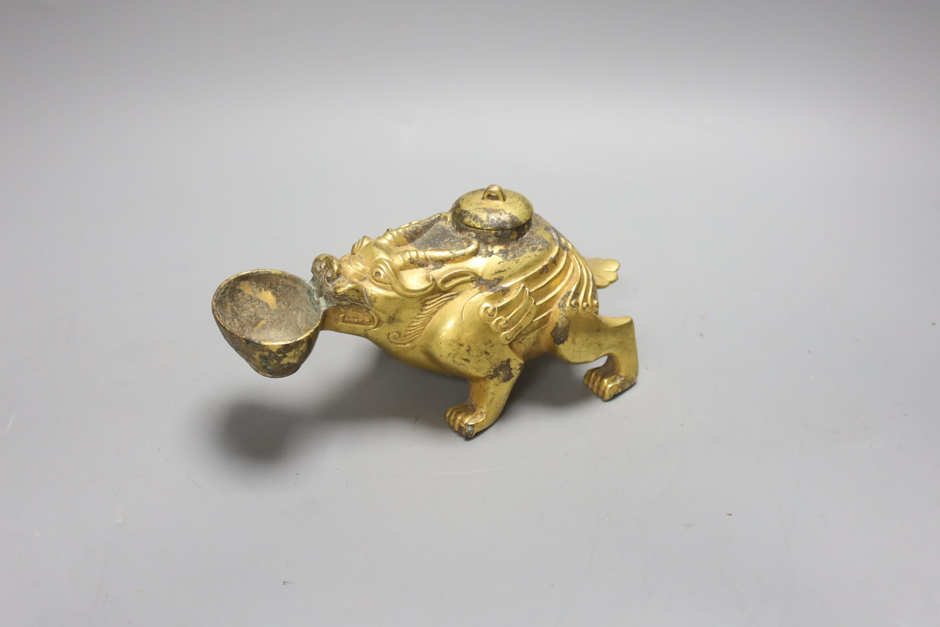 A Chinese gilt bronze mythical beast lamp, width 16cm